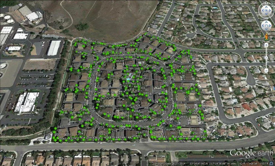 Aerial neighborhood image with trees marked in green